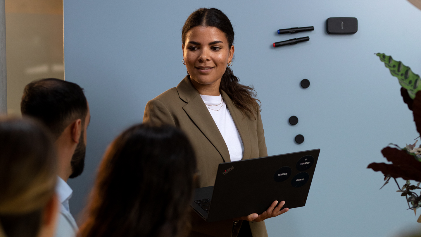 Woman holding a computer in the office