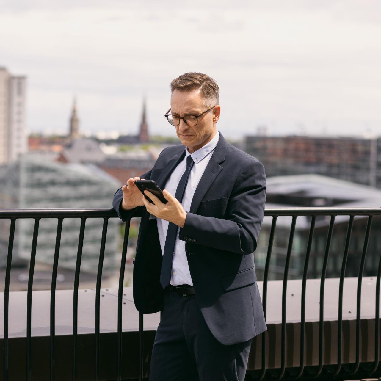 Image of man looking at news at his smartphone