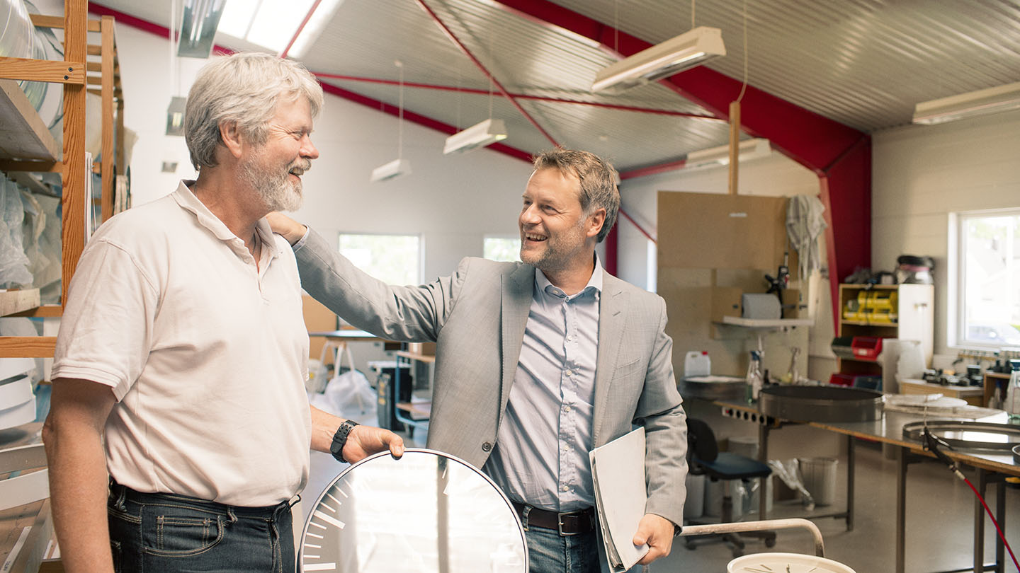 Two men talking in a factory