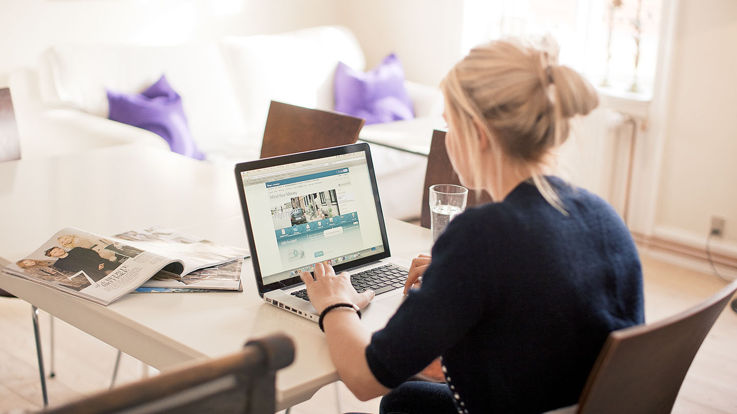 Woman sitting in her livingroom with her computer