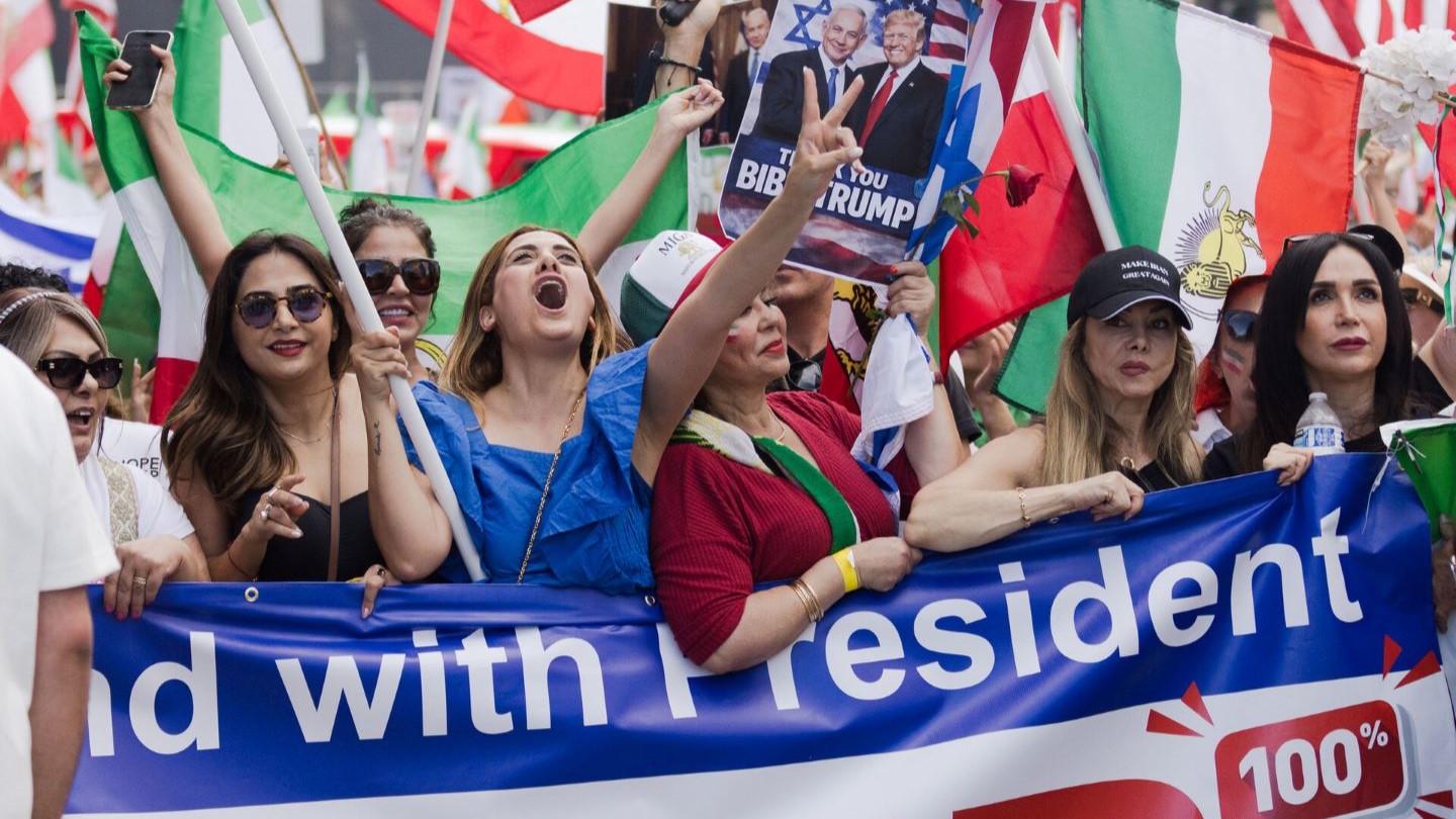 Young woman sitting by laptop in kitchen