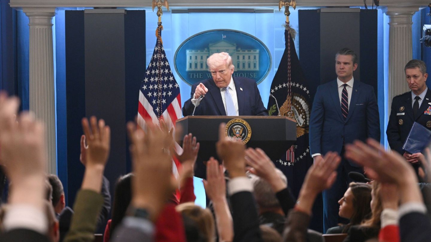Young woman sitting by laptop in kitchen